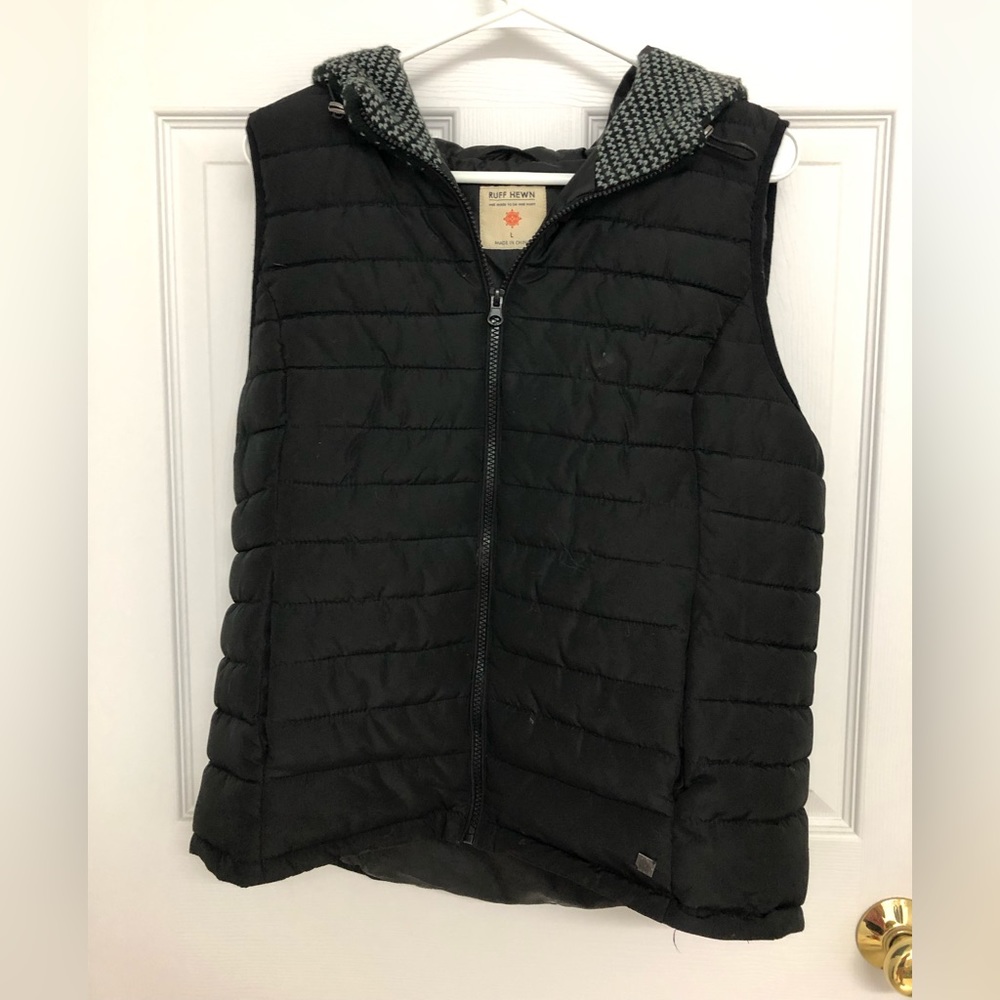 A black winter vest with wool hood